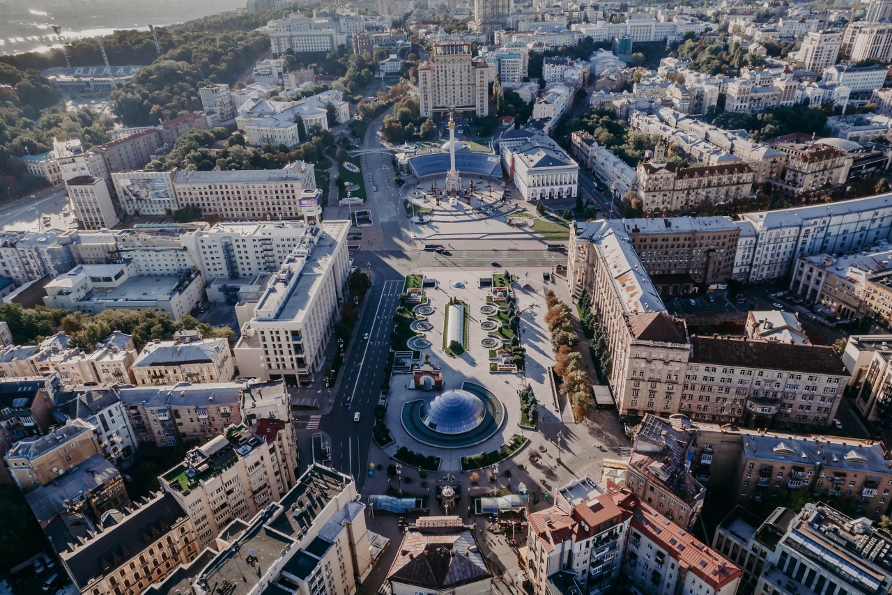 Kyiv, Ukraine - September, 2021: Maidan Nezalezhnosti square, Khreshchatyk and Dnieper river - aerial drone view. Flight over capital - big city with modern architecture Kiev.